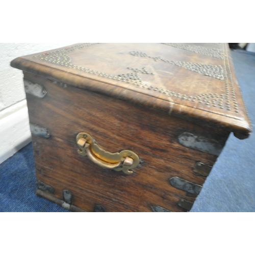 188 - A BRASS-STUDDED HARDWOOD ZANZIBAR CHEST, with twin brass handles, the hinged lid enclosing a candle ... 