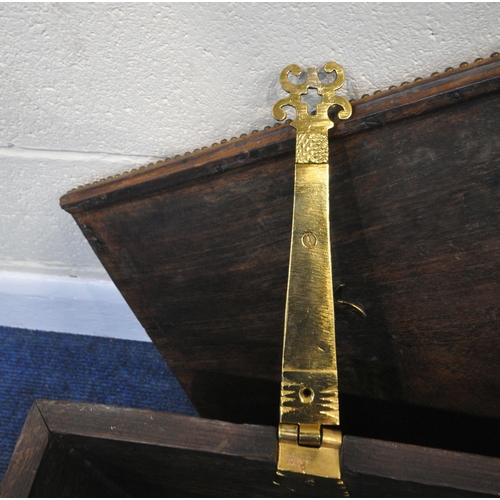 188 - A BRASS-STUDDED HARDWOOD ZANZIBAR CHEST, with twin brass handles, the hinged lid enclosing a candle ... 