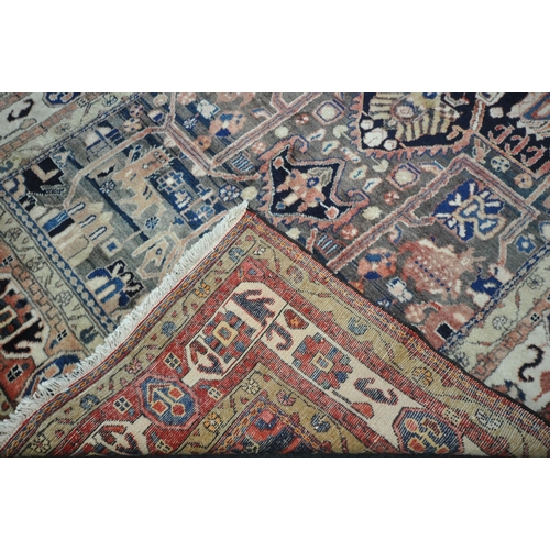 189 - A LARGE RECTANGULAR WOOLEN RUG, with mirrored and repeating geometric patterns, surrounded by a mult... 