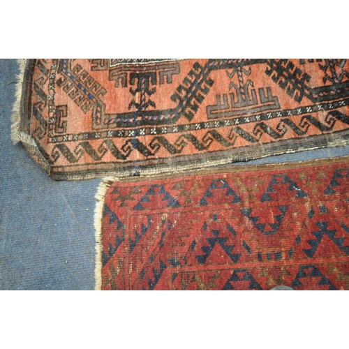 190 - A RED GROUND RECTANGULAR AFGHAN RUG, with twenty-one central medallions, surrounded by a multi-strap... 