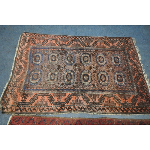 190 - A RED GROUND RECTANGULAR AFGHAN RUG, with twenty-one central medallions, surrounded by a multi-strap... 