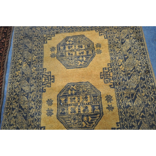 191 - AN AFGHAN GOLD GROUND RUG, with two central medallions, surrounded by a multi-strap border, 121cm x ... 