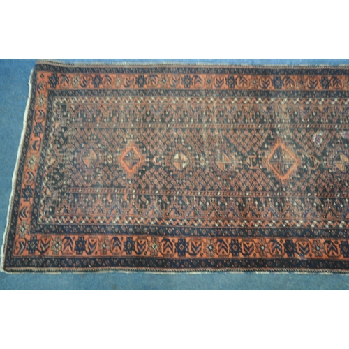 192 - A RED AND BLUE GROUND CARPET RUNNER, with repeating geometric patterns, surrounded by a multi-strap ... 