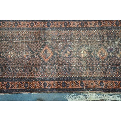 192 - A RED AND BLUE GROUND CARPET RUNNER, with repeating geometric patterns, surrounded by a multi-strap ... 