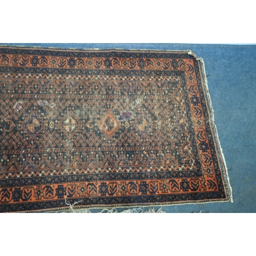 192 - A RED AND BLUE GROUND CARPET RUNNER, with repeating geometric patterns, surrounded by a multi-strap ... 