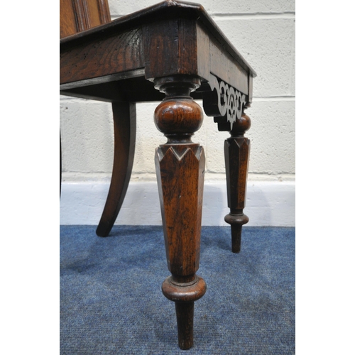 197 - A PAIR OF 20TH CENTURY OAK GOTHIC STYLE HALL CHAIRS, the shaped backrest with quatrefoil details, ra... 