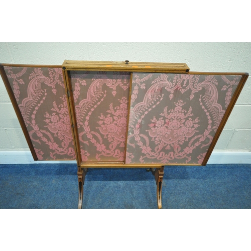 200 - A REGENCY WALNUT FIRE SCREEN, with two sliding screens, and a rise and fall screen, raised on shaped... 