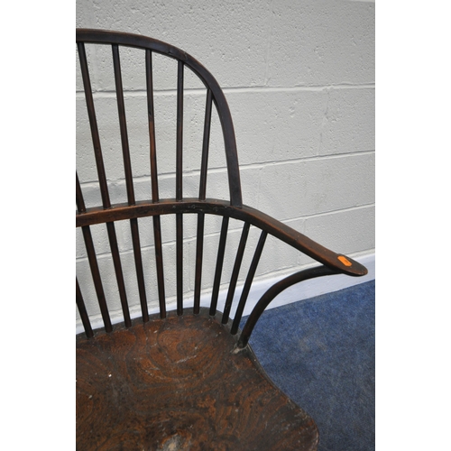 204 - A YEW WOOD WINDSOR HOOP BACK CHAIR, the spindles terminate to shaped armrests, an elm dished seat, r... 