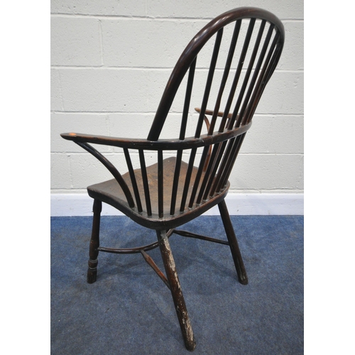 204 - A YEW WOOD WINDSOR HOOP BACK CHAIR, the spindles terminate to shaped armrests, an elm dished seat, r... 