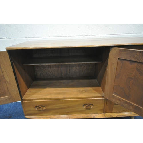 205 - LUCIAN ERCOLANI, ERCOL, A MID CENTURY ELM AND BEECH SIDEBOARD, fitted with three cupboard doors and ... 