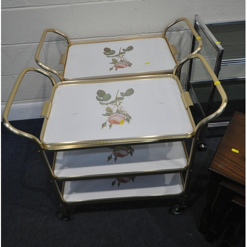 210 - A TUBULAR METAL TWO TIER TROLLEY, with glass inserts, width 66cm x depth 41cm x height 74cm, a pair ... 