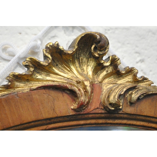 220 - AN OVAL BEVELLED EDGE WALL MIRROR, with a gilt crest, 53cm x 74cm, condition report: general signs o... 