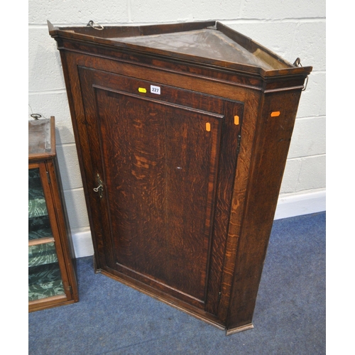 227 - A GEORGIAN OAK CORNER CUPBOARD, the single door enclosing a painted interior, width 83cm x depth 46c... 