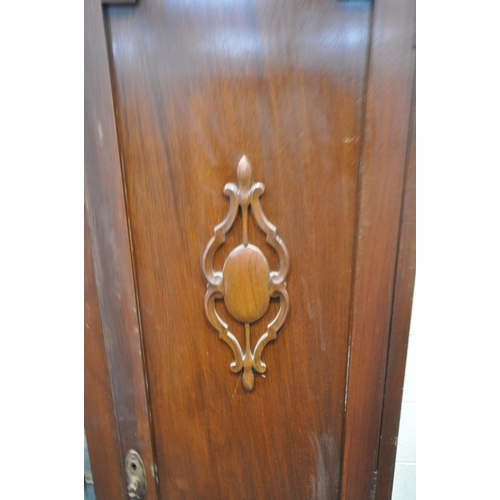 231 - A 20TH CENTURY WARDROBE, with two doors, flanking a bevelled mirror plate, above a single drawer, wi... 