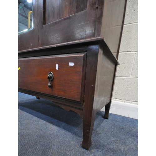 231 - A 20TH CENTURY WARDROBE, with two doors, flanking a bevelled mirror plate, above a single drawer, wi... 