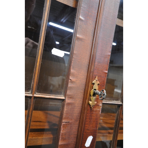 241 - A 20TH CENTURY MAHOGANY BOOKCASE, fitted with double glass doors, over double cupboard doors, width ... 