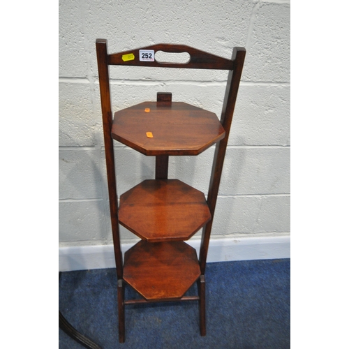 252 - A 20TH CENTURY THREE TIER FOLDING CAKE STAND, with octagonal surfaces, height 98cm a plant stand, an... 