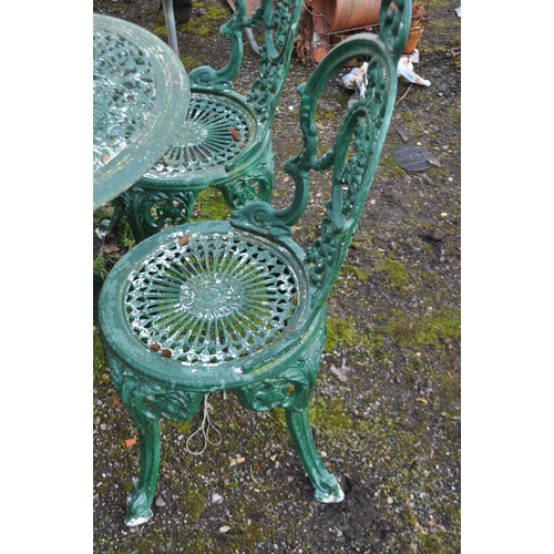 4 - A CAST ALUMINIUM GARDEN TABLE AND FOUR SIMILAR CHAIRS, all overpainted in green, pierced fretwork to... 