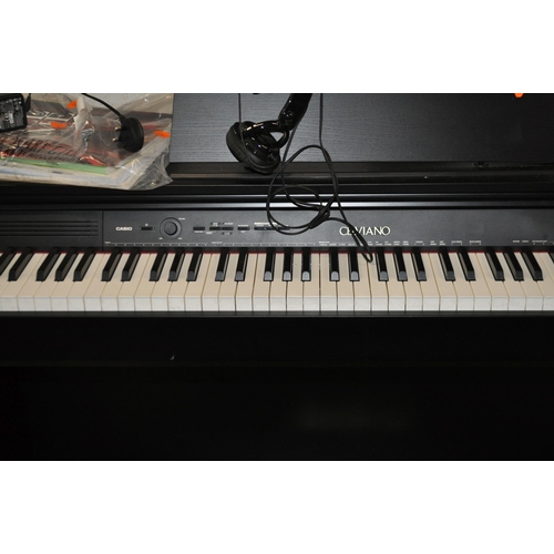 60 - A CASIO CELVIANO AP-245 ELECTRONIC PIANO  with manual, power supply, a Takstar headphone set and a s... 