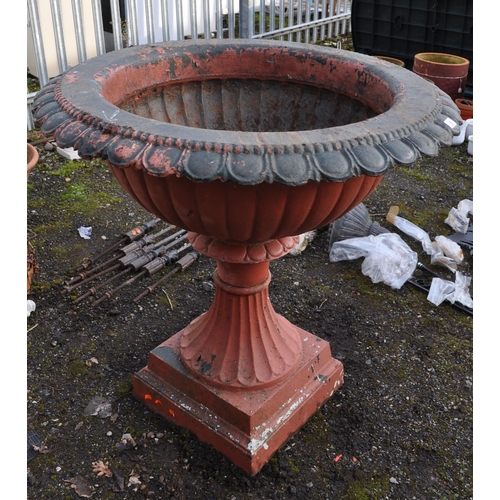 9 - A LARGE EARLY TO MID 20th CENTURY CAST IRON GARDEN URN, with fluted bowl atop a tapered base with a ... 