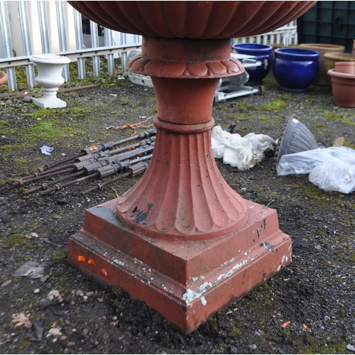 9 - A LARGE EARLY TO MID 20th CENTURY CAST IRON GARDEN URN, with fluted bowl atop a tapered base with a ... 