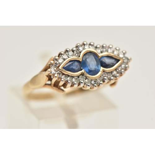 403 - A 9CT GOLD SAPPHIRE AND DIAMOND RING, of a lozenge shape, set with a central oval cut sapphire flank... 