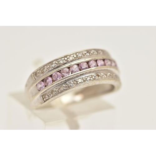 407 - A WHITE METAL GEM SET RING, designed as a central row of circular cut pink sapphires, between two ro... 