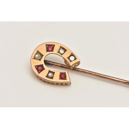 413 - A YELLOW METAL GEM SET, HORSESHOE STICK PIN, set with three circular cut rubies and three rose cut d... 