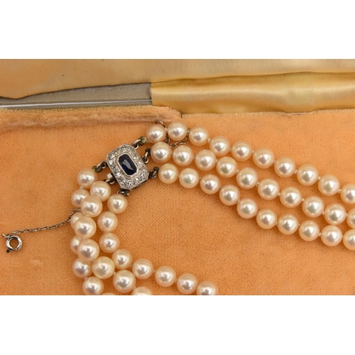 415 - A THREE STRAND CULTURED PEARL NECKLACE, three strands of individually knotted, graduated cream pearl... 