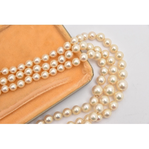 415 - A THREE STRAND CULTURED PEARL NECKLACE, three strands of individually knotted, graduated cream pearl... 