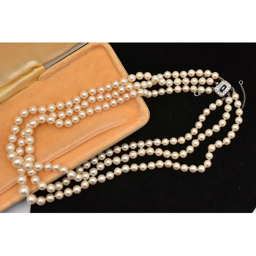 415 - A THREE STRAND CULTURED PEARL NECKLACE, three strands of individually knotted, graduated cream pearl... 