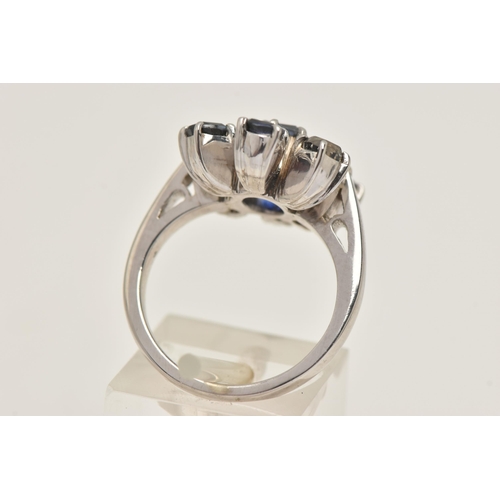 416 - A WHITE METAL SAPPHIRE AND DIAMOND CLUSTER RING, set with a central oval cut sapphire, flanked with ... 