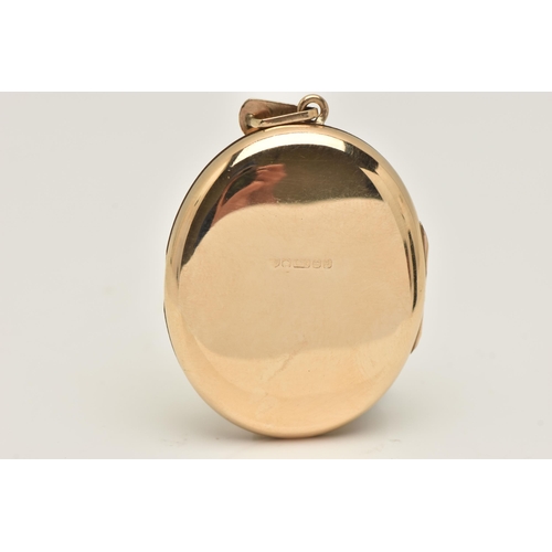 420 - A 9CT GOLD OVAL LOCKET, floral pattern, opens to reveal two vacant compartments, fitted with a taper... 