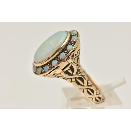 431 - AN OPAL CLUSTER RING, with locket component, set with an oval opal cabochon, surrounded by circular ... 