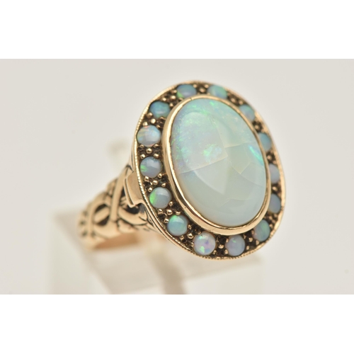 431 - AN OPAL CLUSTER RING, with locket component, set with an oval opal cabochon, surrounded by circular ... 