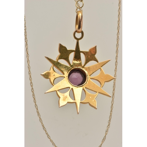 433 - A YELLOW METAL AMETHYST AND SEED PEARL PENDANT AND CHAIN, circular star shape pendant set with a cen... 