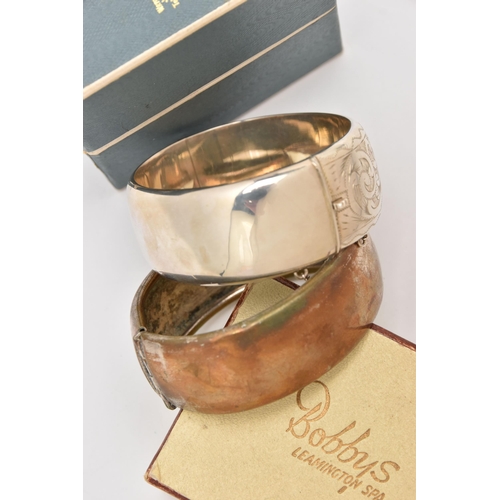 507 - TWO HINGED BANGLES, the first a silver bangle with box, foliate pattern with push button clasp and a... 