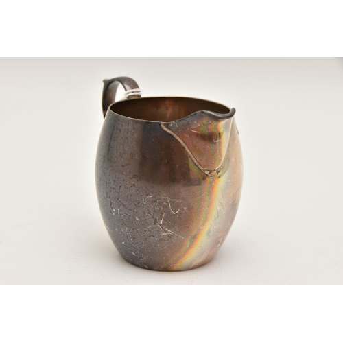 537 - A SILVER MILK JUG, small plain jug with scrolling handle and monogram engraving, approximate height ... 