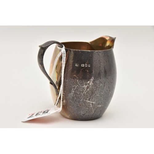 537 - A SILVER MILK JUG, small plain jug with scrolling handle and monogram engraving, approximate height ... 