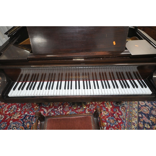 152 - A DANEMANN MAHOGANY CASED BABY GRAND PIANO, the hinged lid enclosing a cast iron over strung frame, ... 