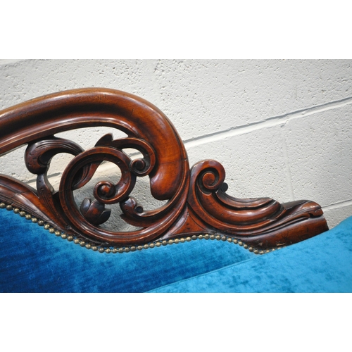 171 - A VICTORIAN MAHOGANY CHAISE LOUNGE, with blue upholstery, scrolled and foliate designs, raised on tu... 