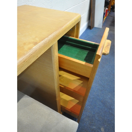 190 - A MODERN LIGHT OAK DESK, fitted with a three tier pull out section, and three drawers, width 166cm x... 