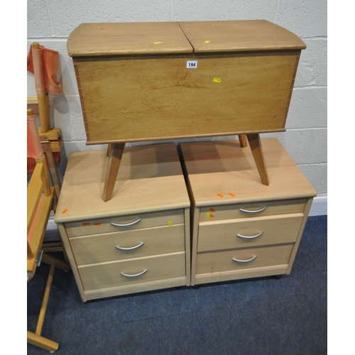 194 - A 20TH CENTURY OAK SEWING BOX, with a twin pull out surface, raised on splayed and tapered legs, wid... 