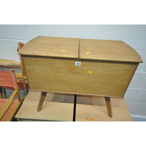 194 - A 20TH CENTURY OAK SEWING BOX, with a twin pull out surface, raised on splayed and tapered legs, wid... 