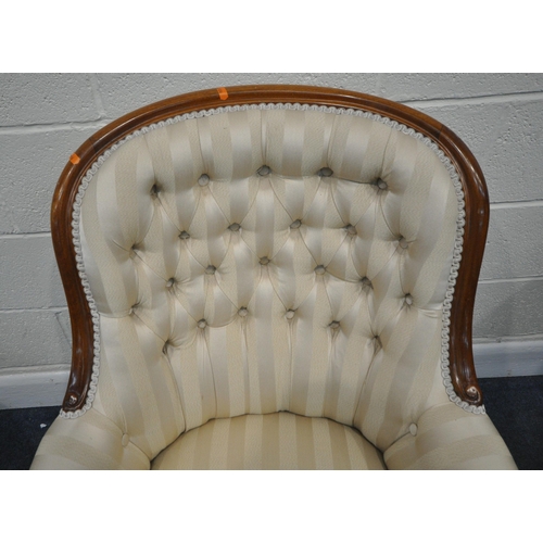 198 - A VICTORIAN HOOP BACK ARMCHAIR, with buttoned backrest, scrolled armrests, raised on shaped legs, an... 