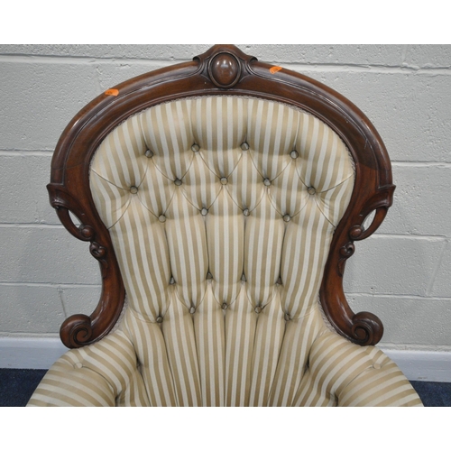 199 - A VICTORIAN ARMCHAIR, the hoop back with scrolled details and a shaped crest, scrolled armrests, rai... 