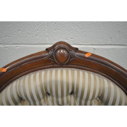 199 - A VICTORIAN ARMCHAIR, the hoop back with scrolled details and a shaped crest, scrolled armrests, rai... 