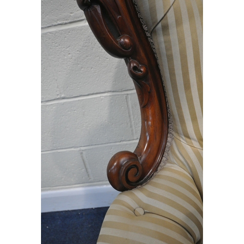 199 - A VICTORIAN ARMCHAIR, the hoop back with scrolled details and a shaped crest, scrolled armrests, rai... 