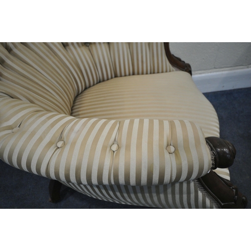 199 - A VICTORIAN ARMCHAIR, the hoop back with scrolled details and a shaped crest, scrolled armrests, rai... 