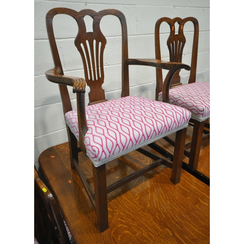 200 - A LARGE 20TH CENTURY OAK WIND OUT DINING TABLE, with three additional leaves, raised on reeded and t... 